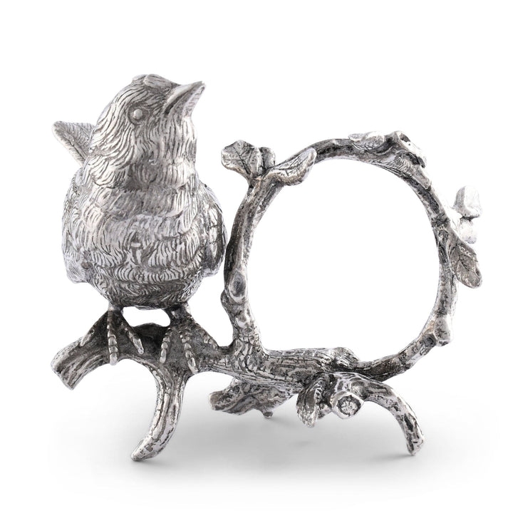 Silver bird figurine napkin holder on a branch with a decorative frame on a white background