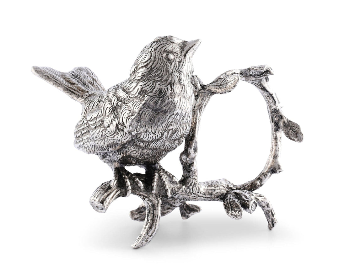 Silver bird figurine napkin holder on a branch with a white background