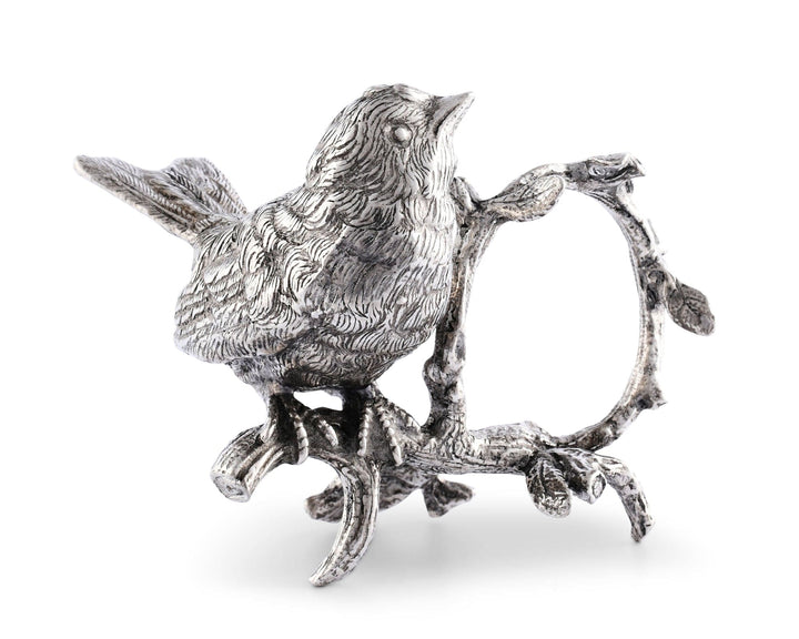 Silver bird figurine napkin holder on a branch with a white background