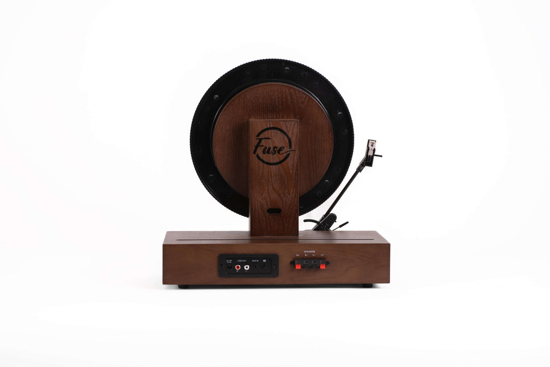 Wooden record player device with a circular component on a white background