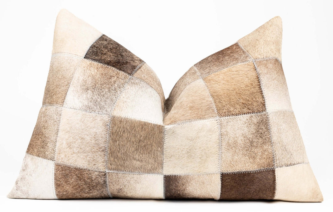 Patchwork cowhide pillow on a white background