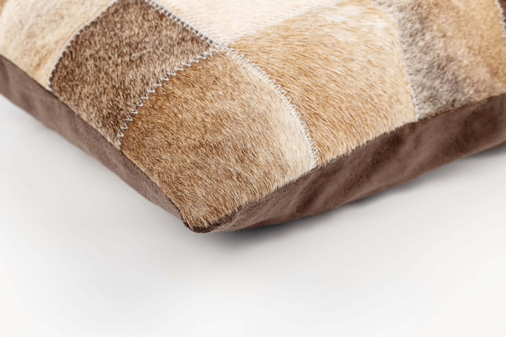 Patchwork pillow with brown and beige colors on a white background