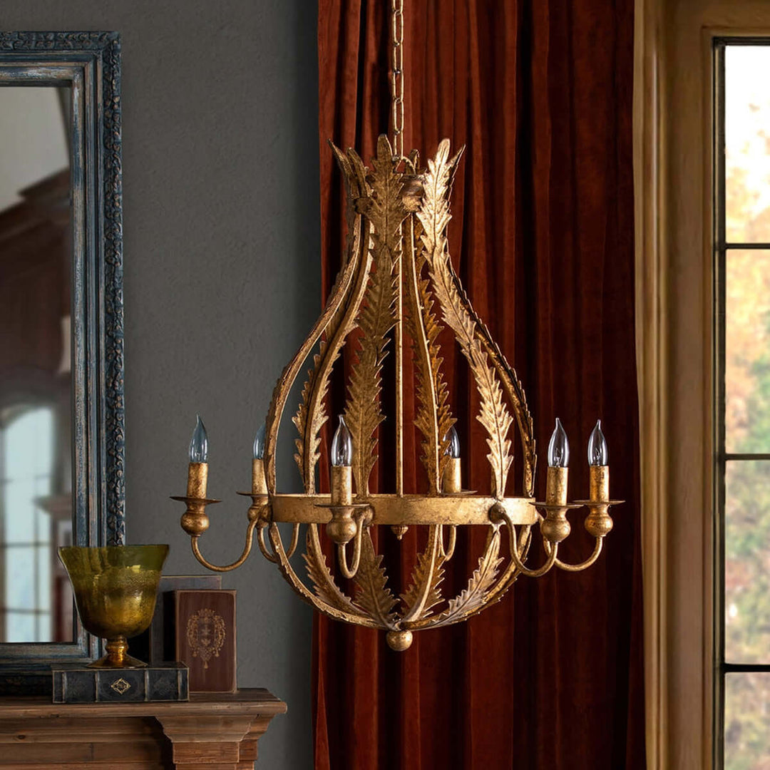 Decorative gold chandelier hanging in a room with a mirror and window.