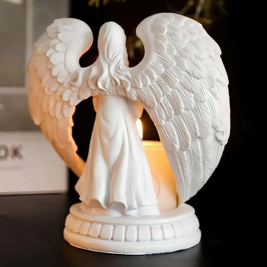 Guardian Angel Candle Holder with intricate wings, casting a warm glow, perfect for vintage decor.