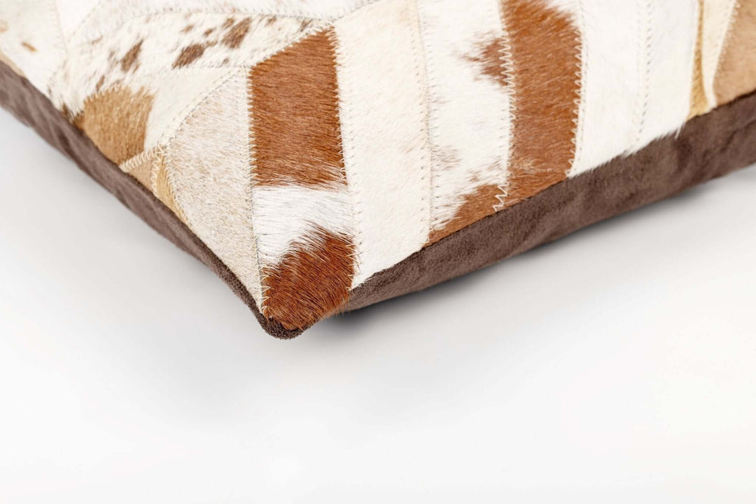 Close-up of a brown and white patterned pillow on a white background