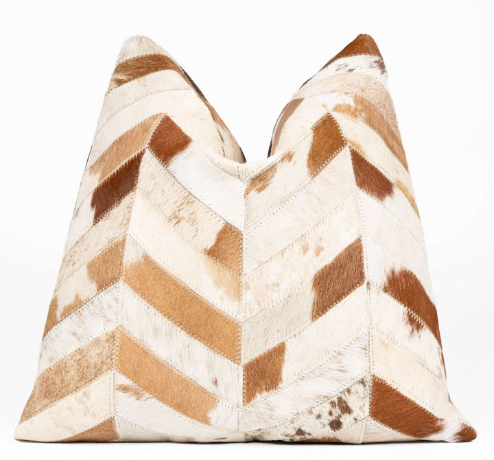 Decorative pillow with brown and white chevron pattern on a white background
