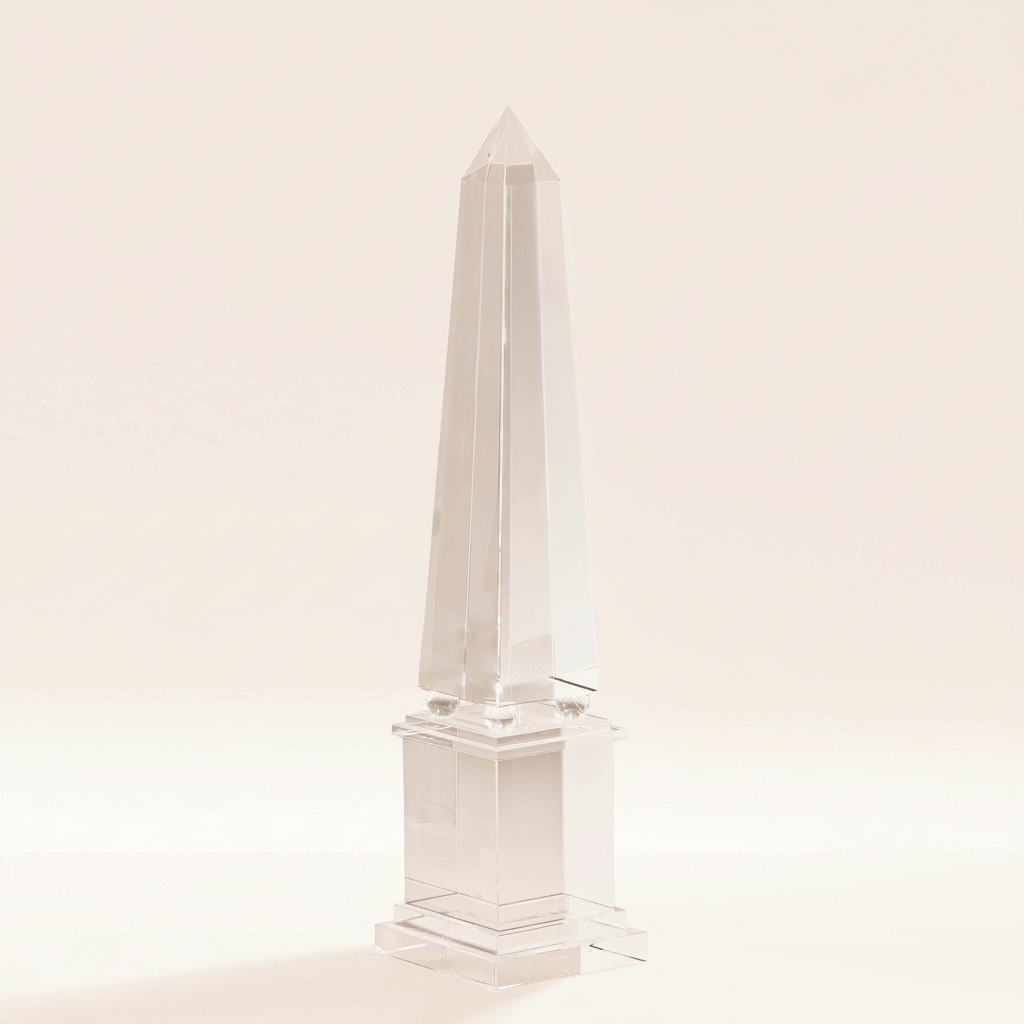 Handcrafted Crystal Obelisk Sculpture by Ian K. Fowler on display against a light background, showcasing elegant and luminous geometry.