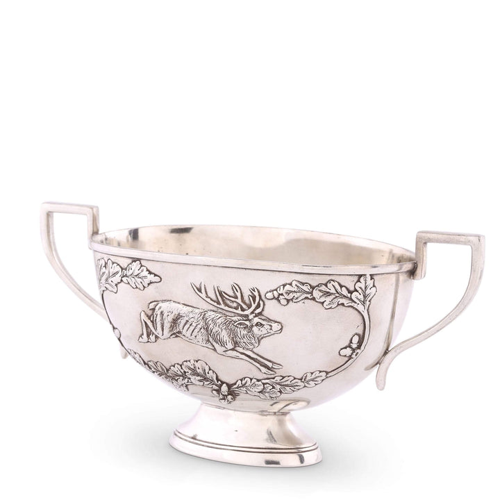 Silver bowl with engraved design on a white background