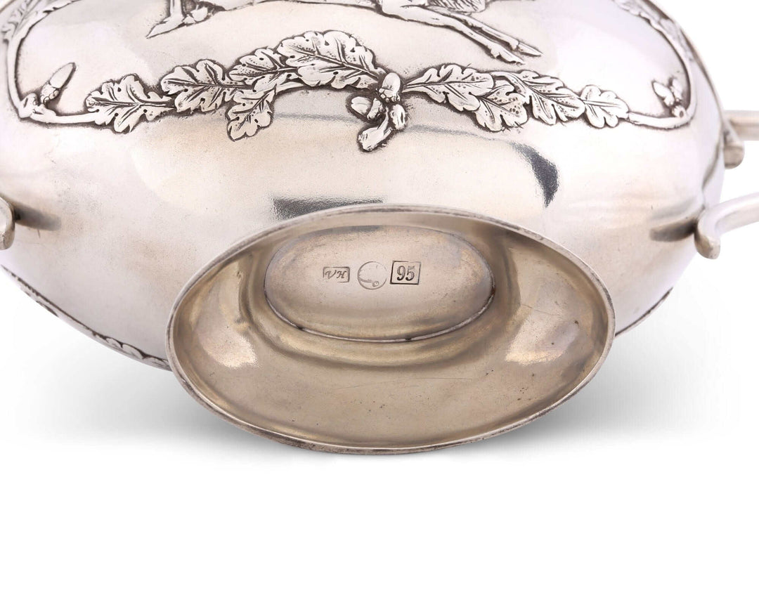 Silver bowl with engraved design on a white background