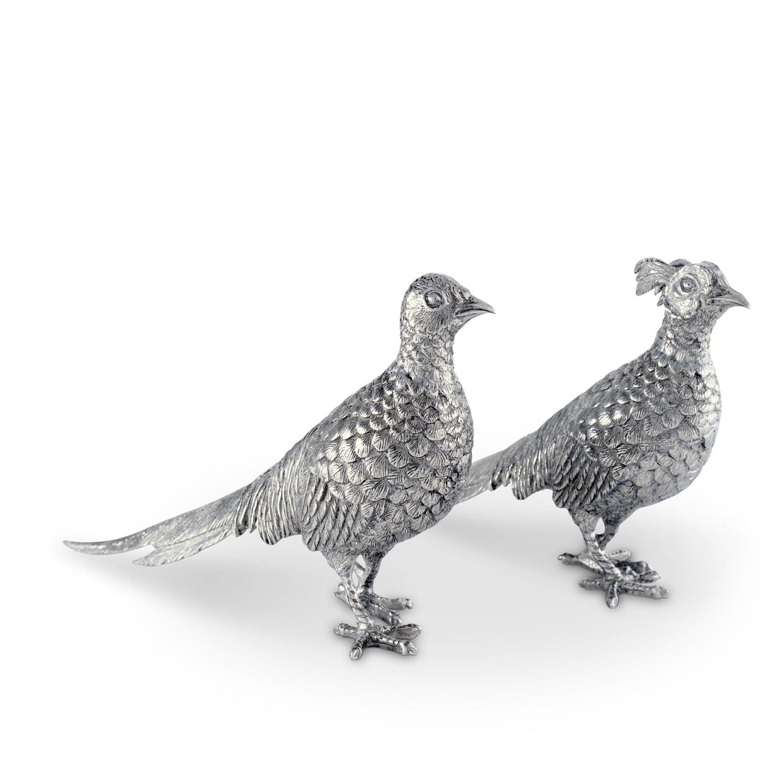 Two silver pheasant figurines on a white background