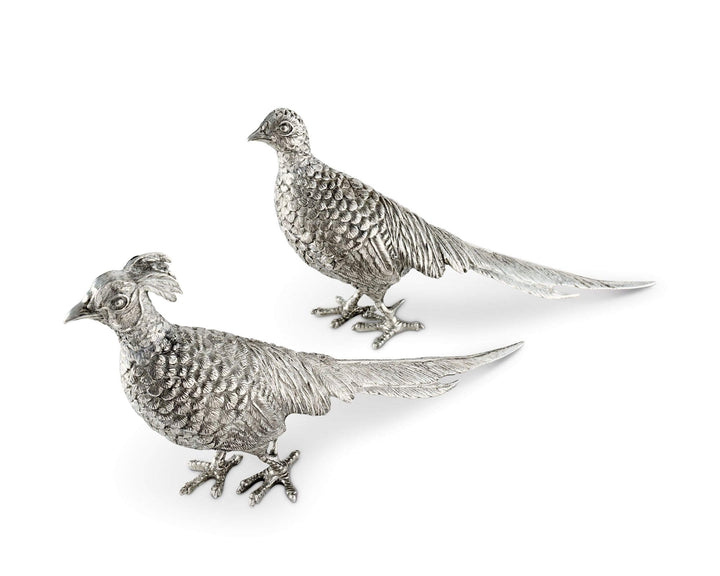 Two silver pheasant figurines on a white background
