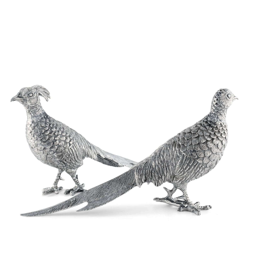 Two silver pheasant figurines on a white background