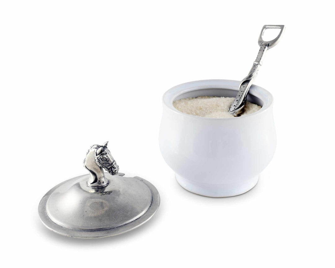White ceramic container with silver lid and spoon on a white background
