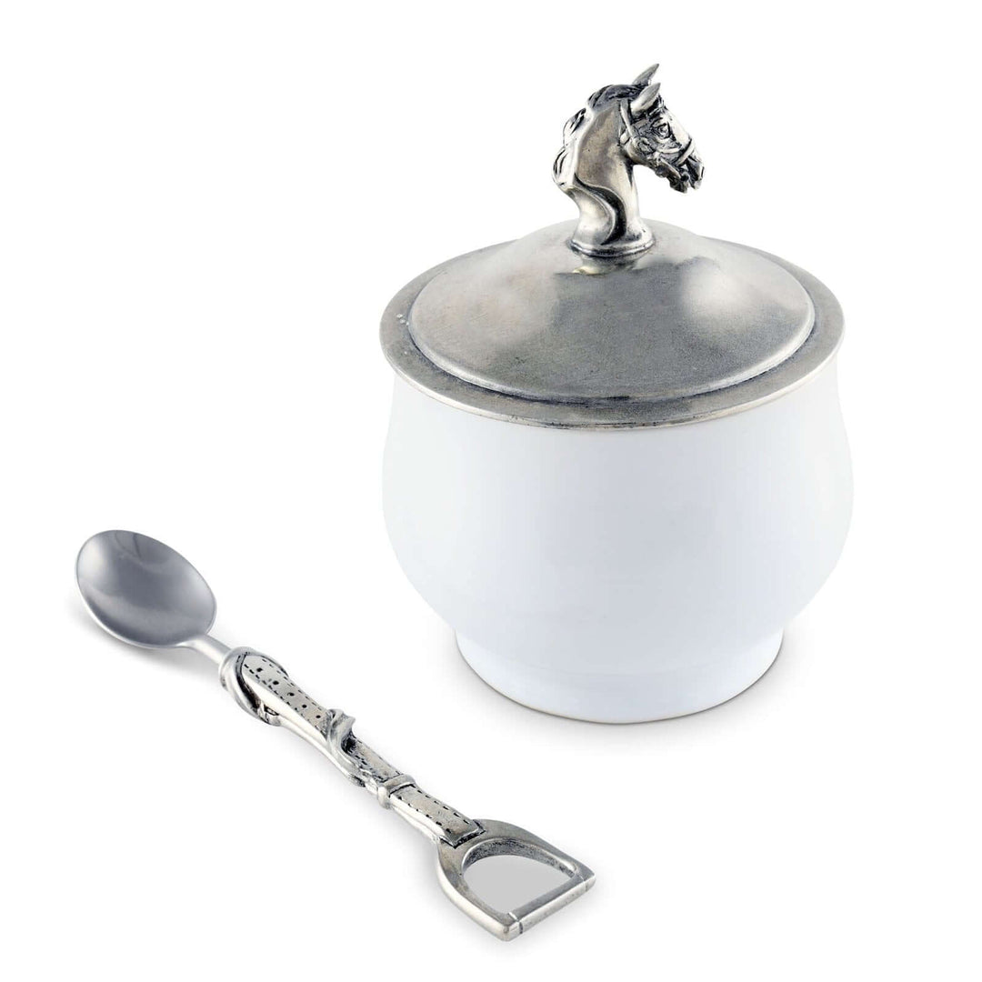 White container with silver unicorn lid and matching spoon on a white background