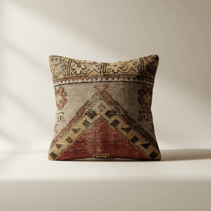 Decorative pillow with geometric pattern on a beige background