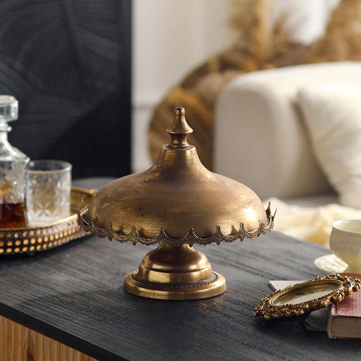 Metal cloche on a table with a cozy indoor setting