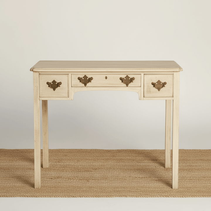 Wooden table with three drawers on a plain background