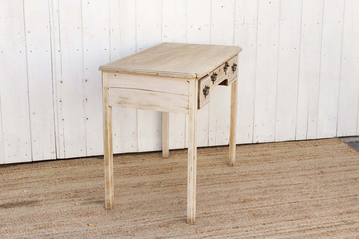 Wooden table with a white paneled wall background