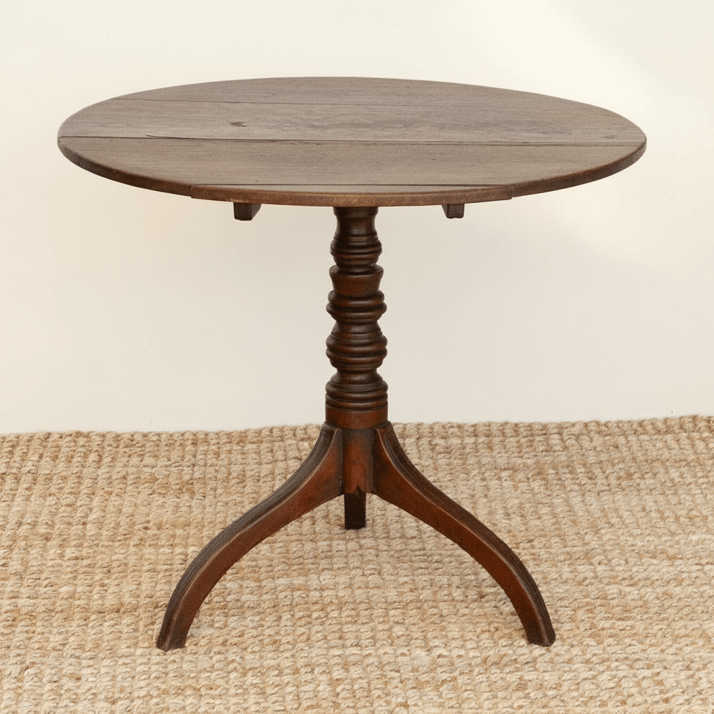 Round wooden table with a pedestal base on a beige rug