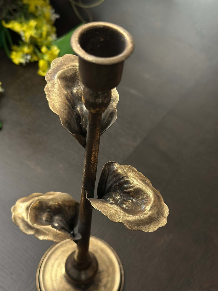 Vintage-inspired brass leaf candle holder, ornate design with golden-bronze patina, perfect for elegant decor.