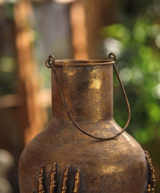 Gothic Skeleton Hands Iron Vase with antique gold finish and detailed skeleton hand design.