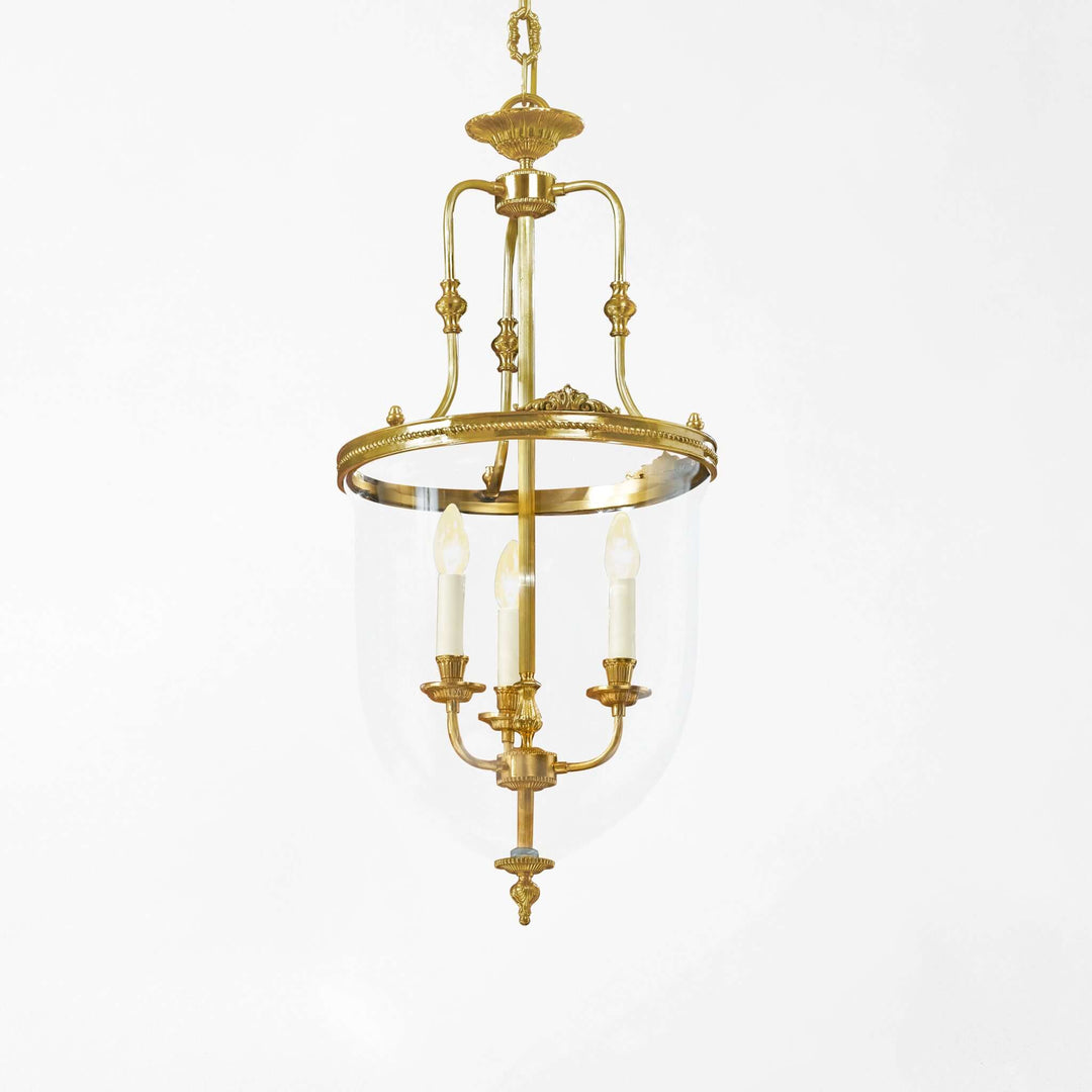 Gold pendant light fixture on a white background