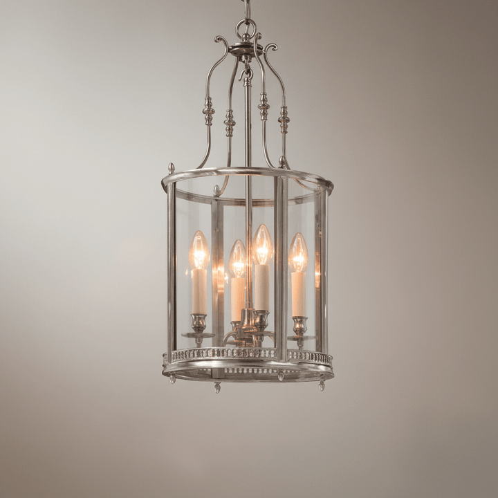 Decorative pendant light with glass panels on a neutral background