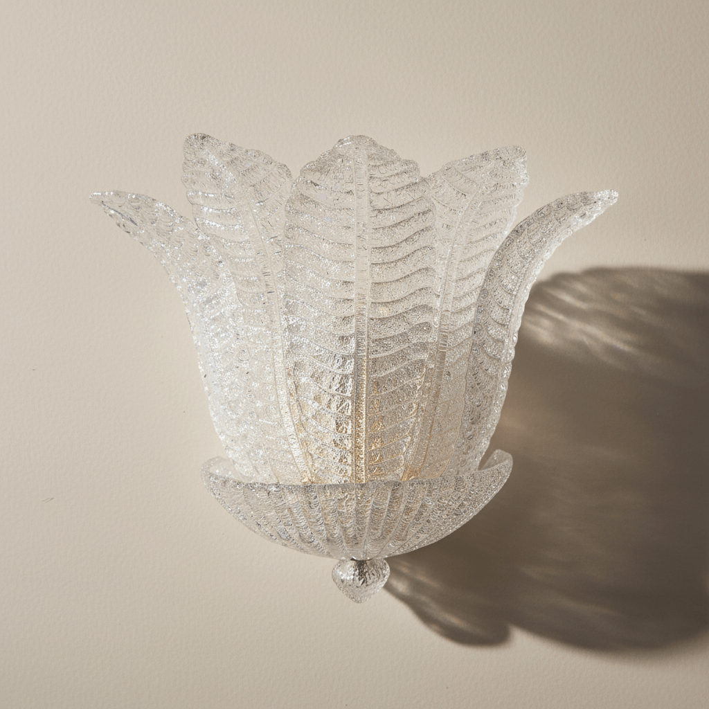 Decorative wall light fixture with a floral design on a beige wall.