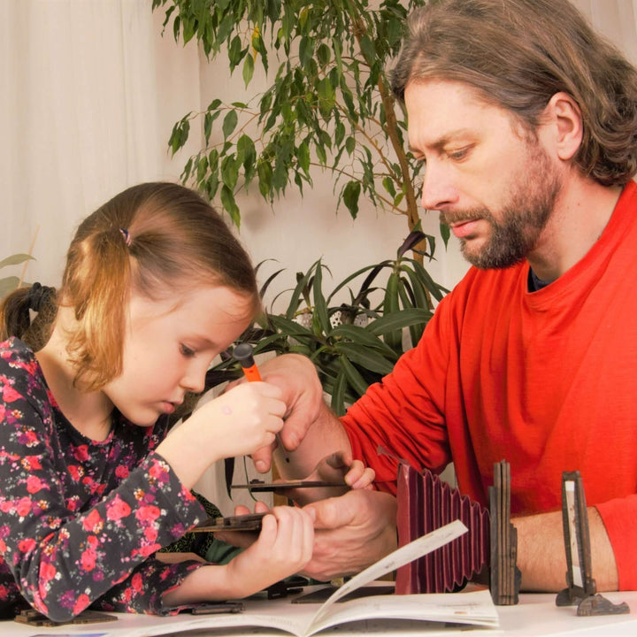 Father and daughter building the Pinhole Square Instant Film Camera DIY Kit together