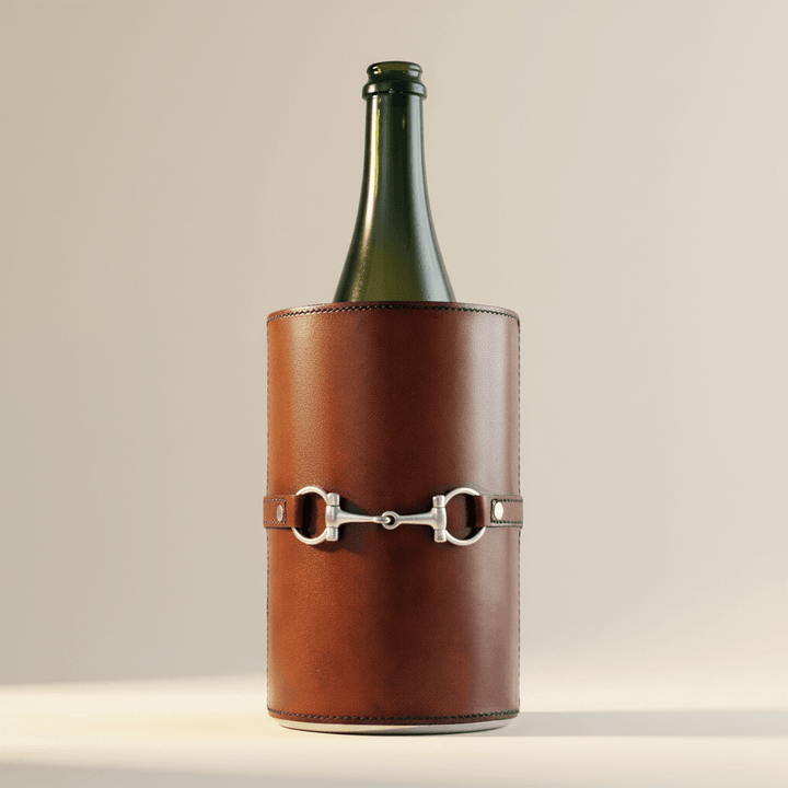 Brown leather wine cooler with silver buckle on a beige background