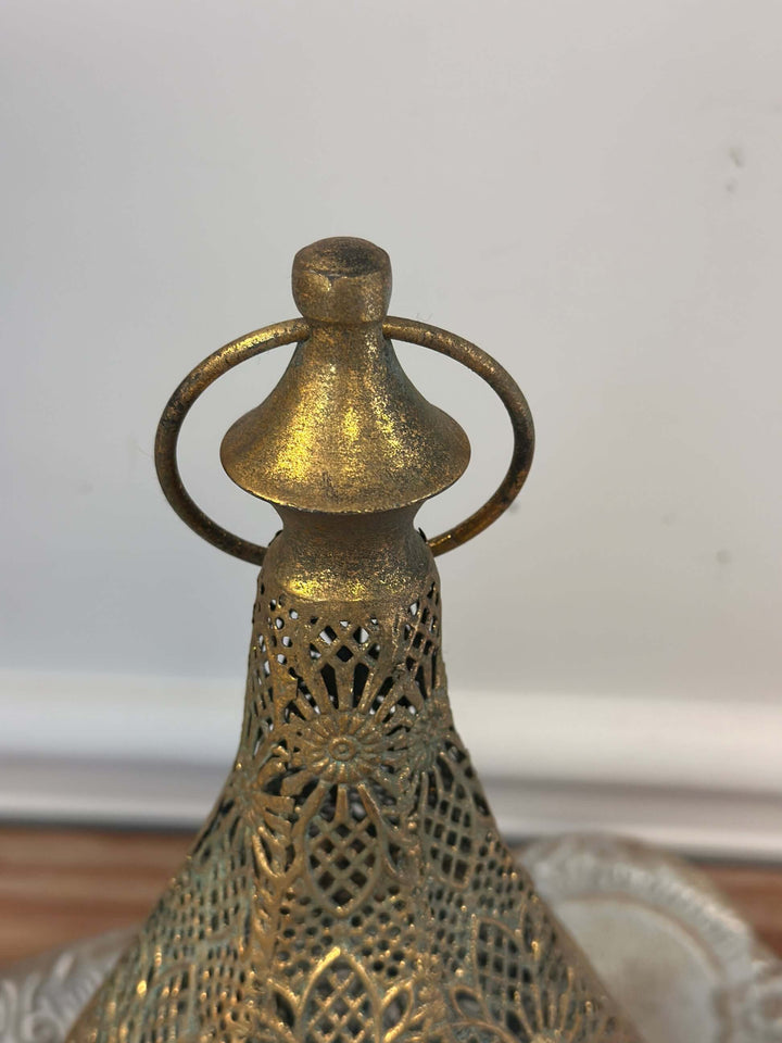 Vintage brass teardrop lantern with intricate floral filigree design top view showcasing craftsmanship and old-world charm.