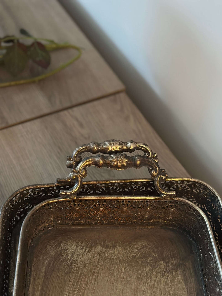 Antique brass filigree serving tray set with a vintage design, showcasing intricate craftsmanship and golden patina.