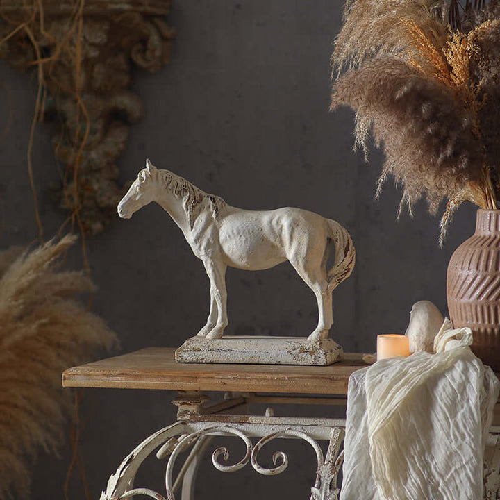 Decorative horse statue on a wooden table with a dark background