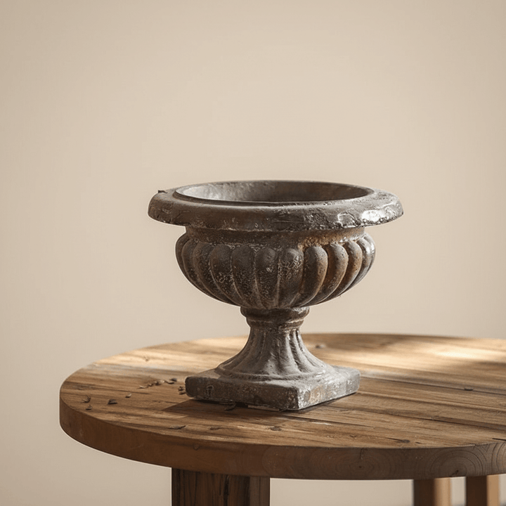 Decorative urn on a wooden table with a beige background