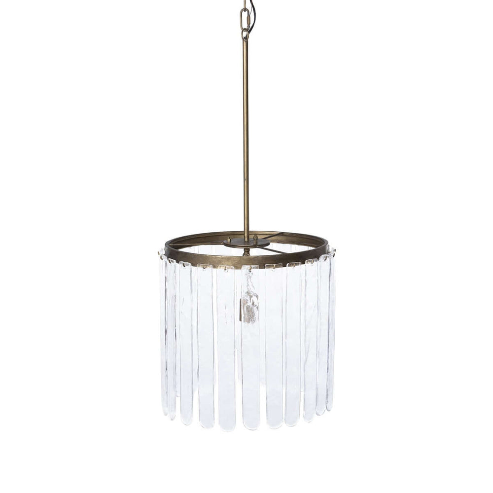 Pendant light with clear glass shade and brass fixture on a white background