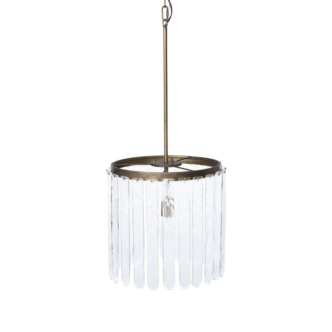 Pendant light with clear glass shade and brass fixture on a white background