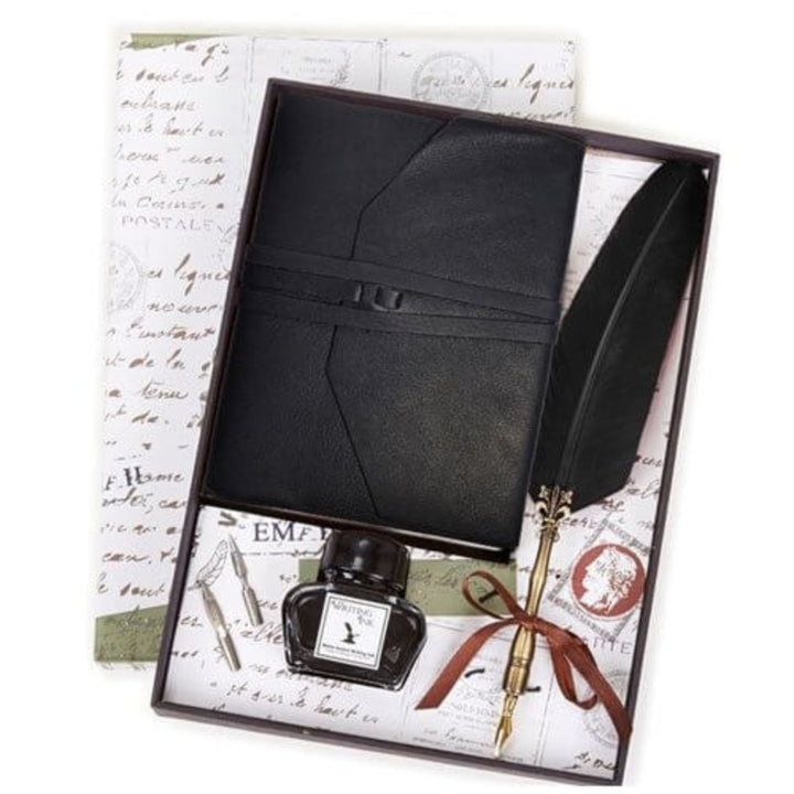Black leather journal set with ink bottle and feather quill in a decorative box.
