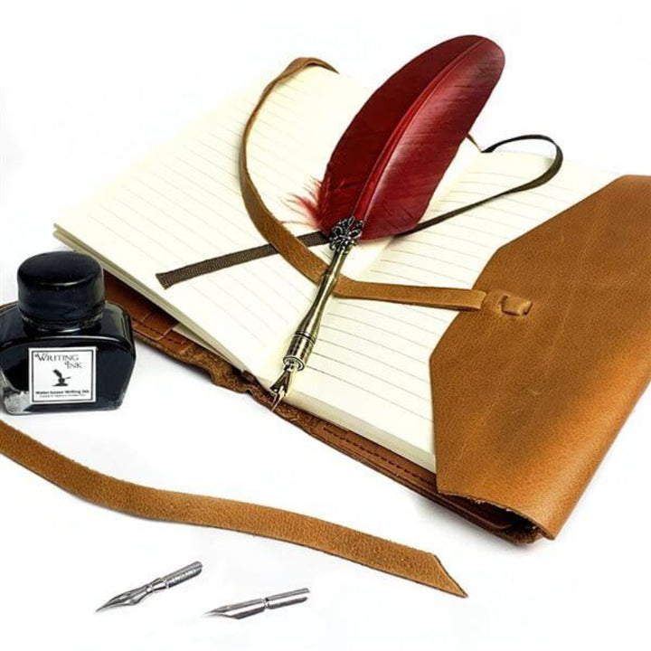 Feather quill pen with ink bottle and leather case on a notebook