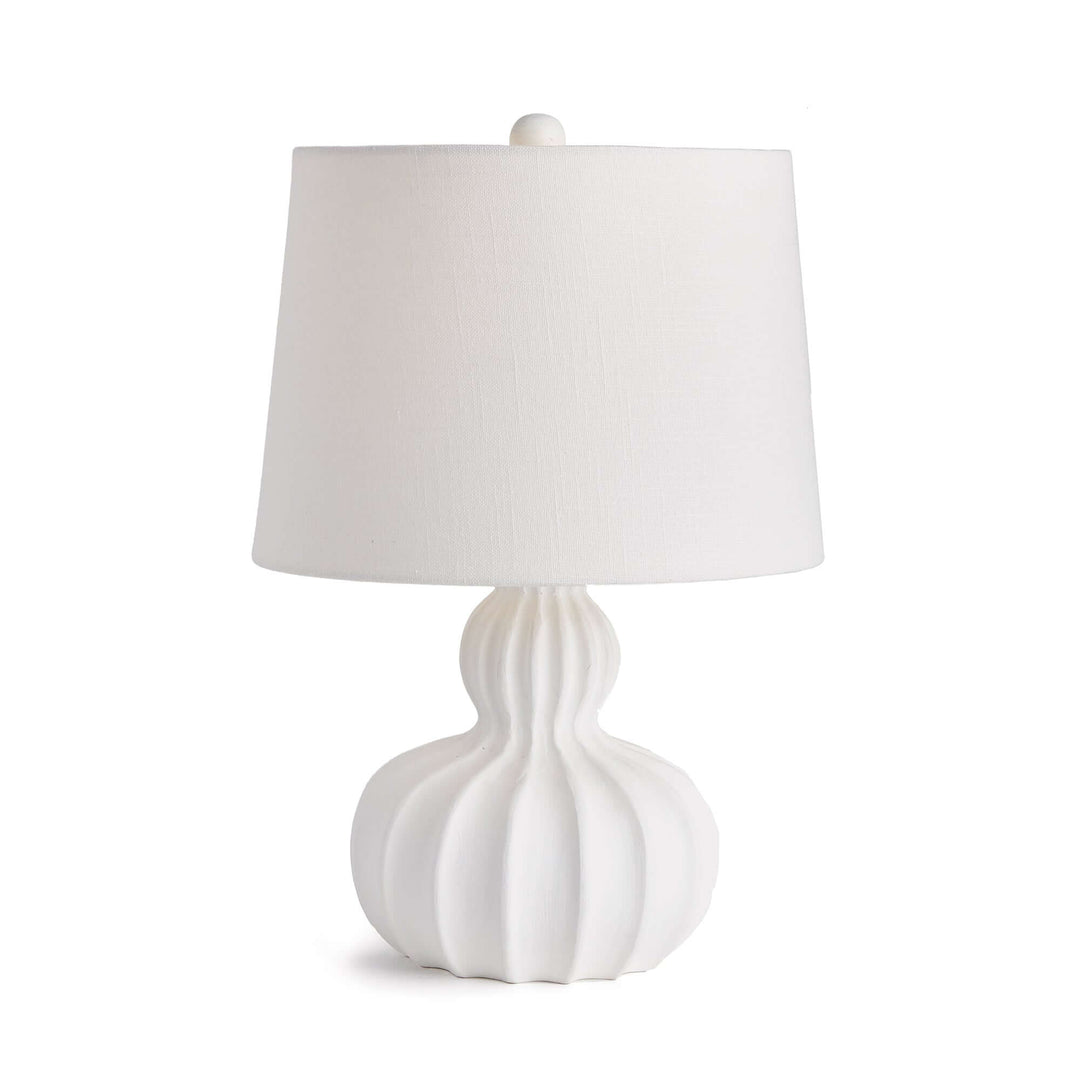White carved wood table lamp with curved base and elegant fluted design, providing soft sophistication for home decor.