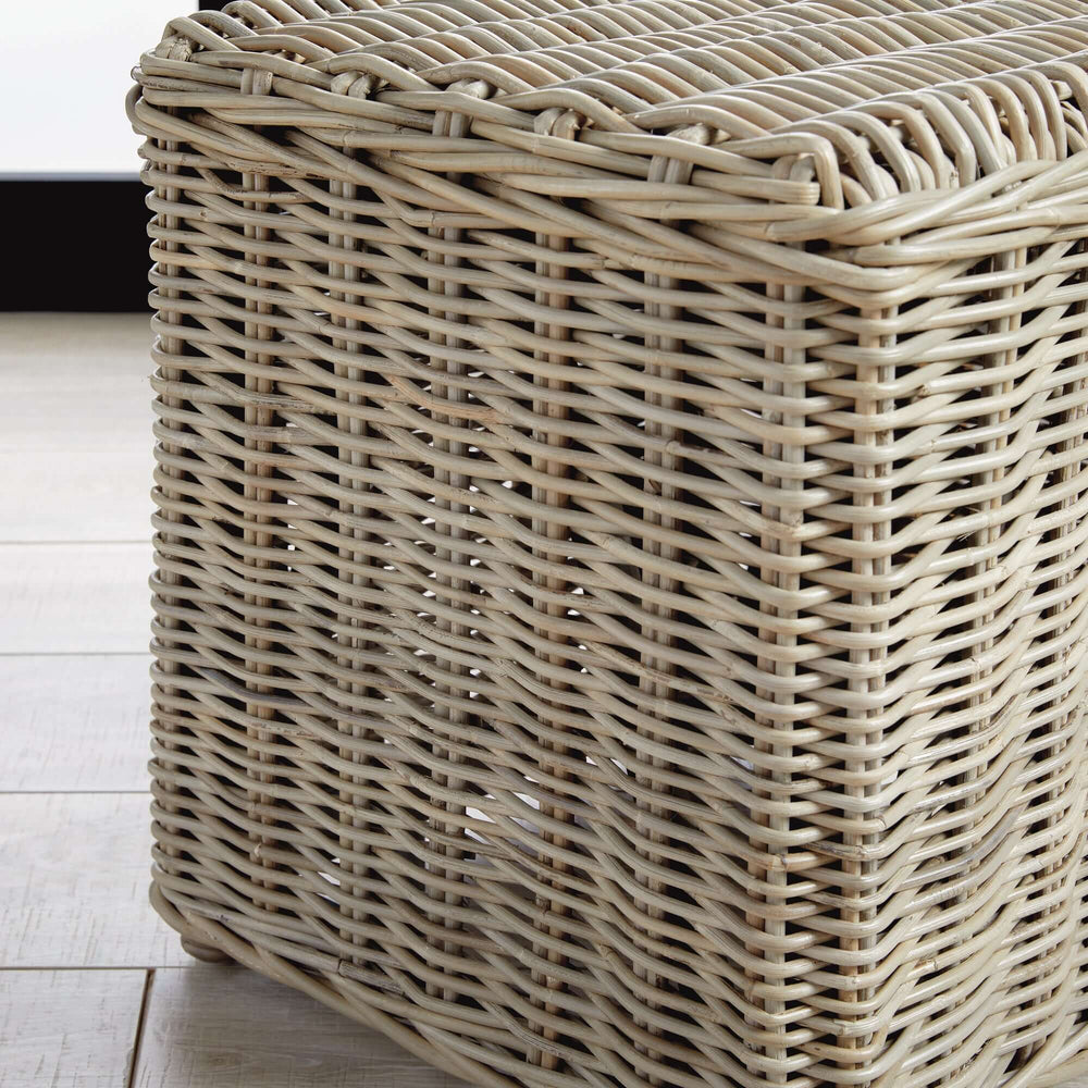 Handwoven Kubu rattan side table showcasing woven texture and warm gray finish in a coastal-inspired living space.