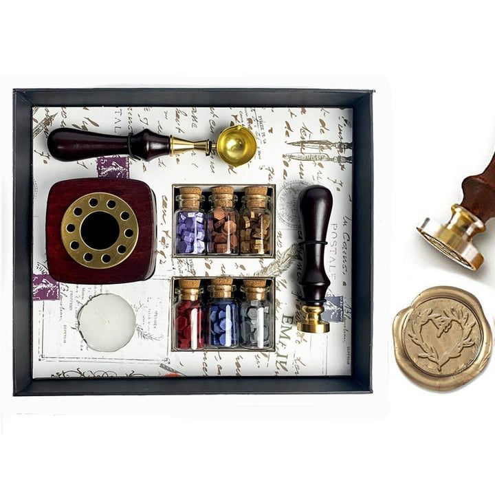 Wax sealing kit with stamp, ink wells, and seals on a decorative background
