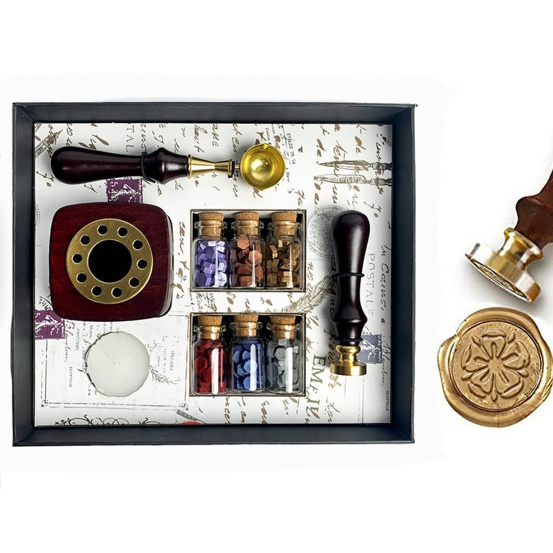 Wax sealing kit with stamp, ink, and seal on a decorative background