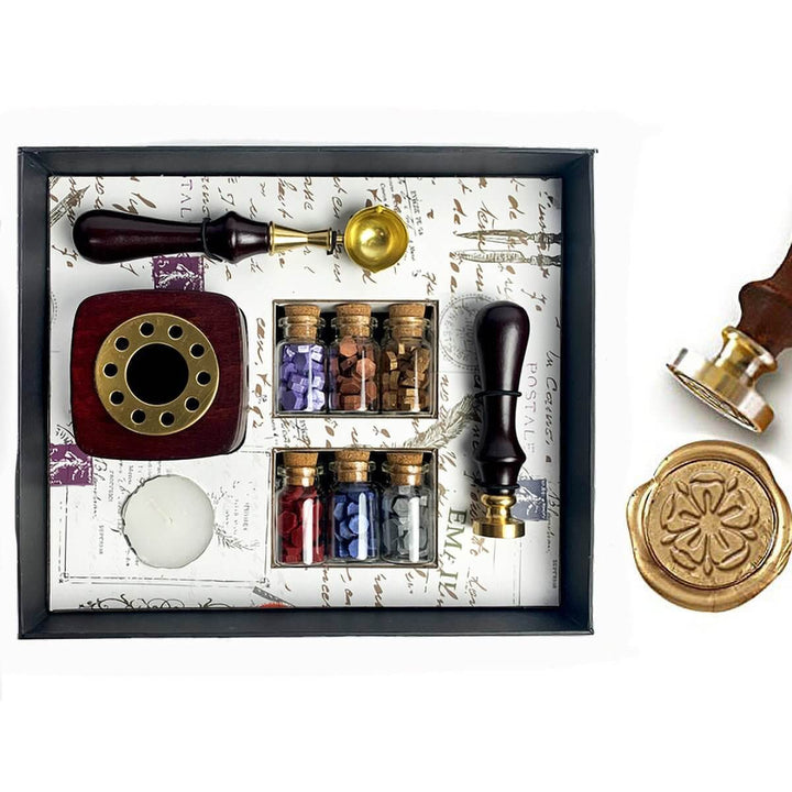 Wax sealing kit with stamp, ink, and seal on a decorative background