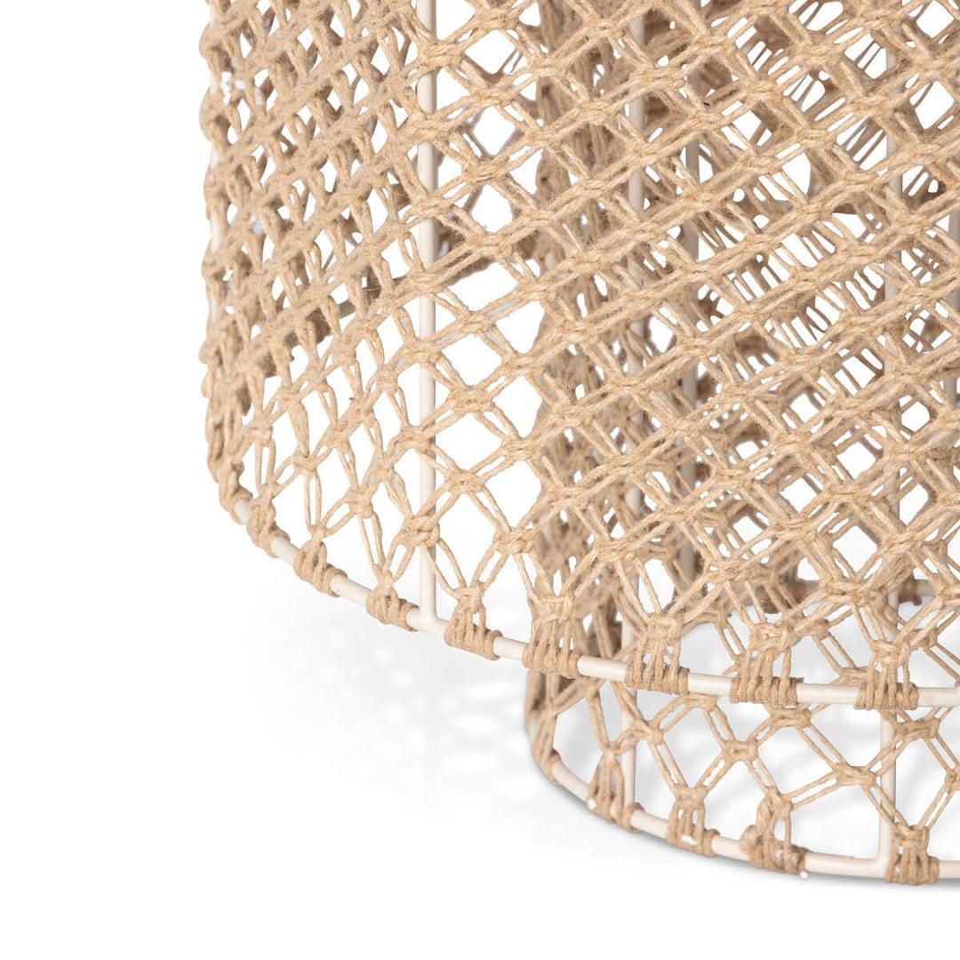 Close-up of a woven light with a geometric pattern on a white background