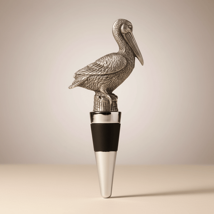 Metallic pelican-shaped bottle stopper on a neutral background