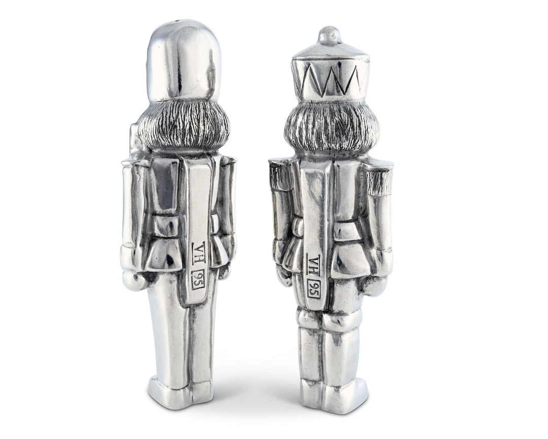 Two silver nutcracker salt and pepper shakers on a white background