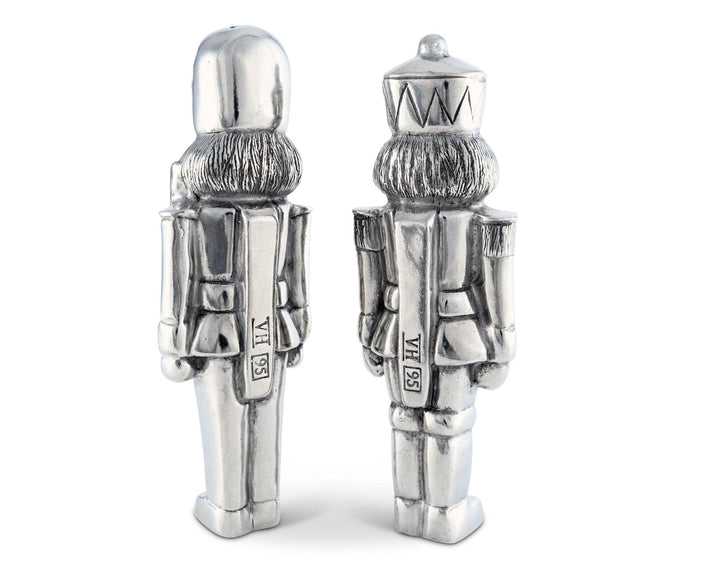 Two silver nutcracker salt and pepper shakers on a white background