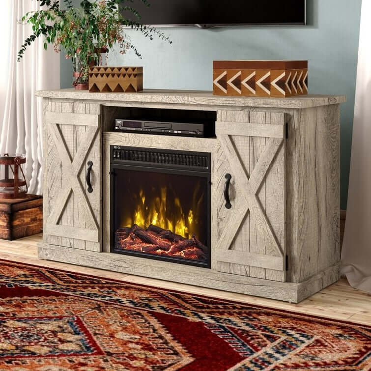 Wooden entertainment console with electric fireplace and TV above, on a patterned rug.