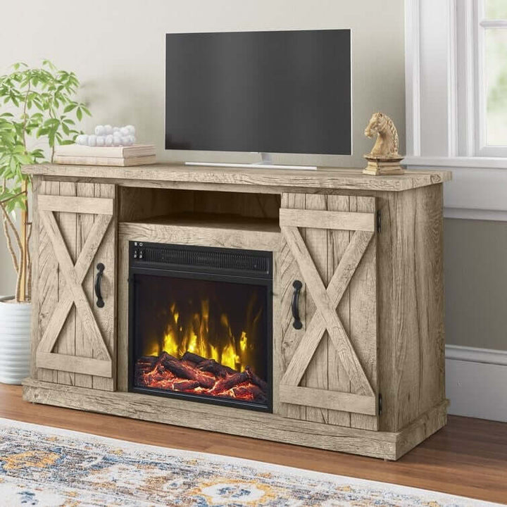 Wooden TV stand with electric fireplace and TV in a room with a plant and rug.