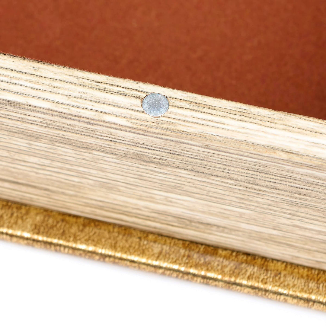 Close-up of a gold and silver ring on a brown background